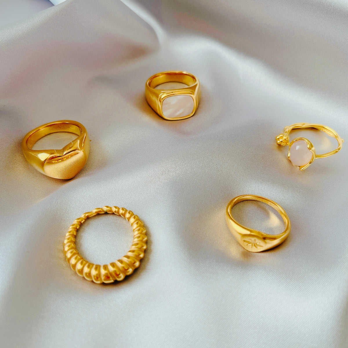 gold flat signet ring worn on model hand