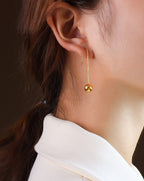 long teardrop earrings gold styling lifestyle shot