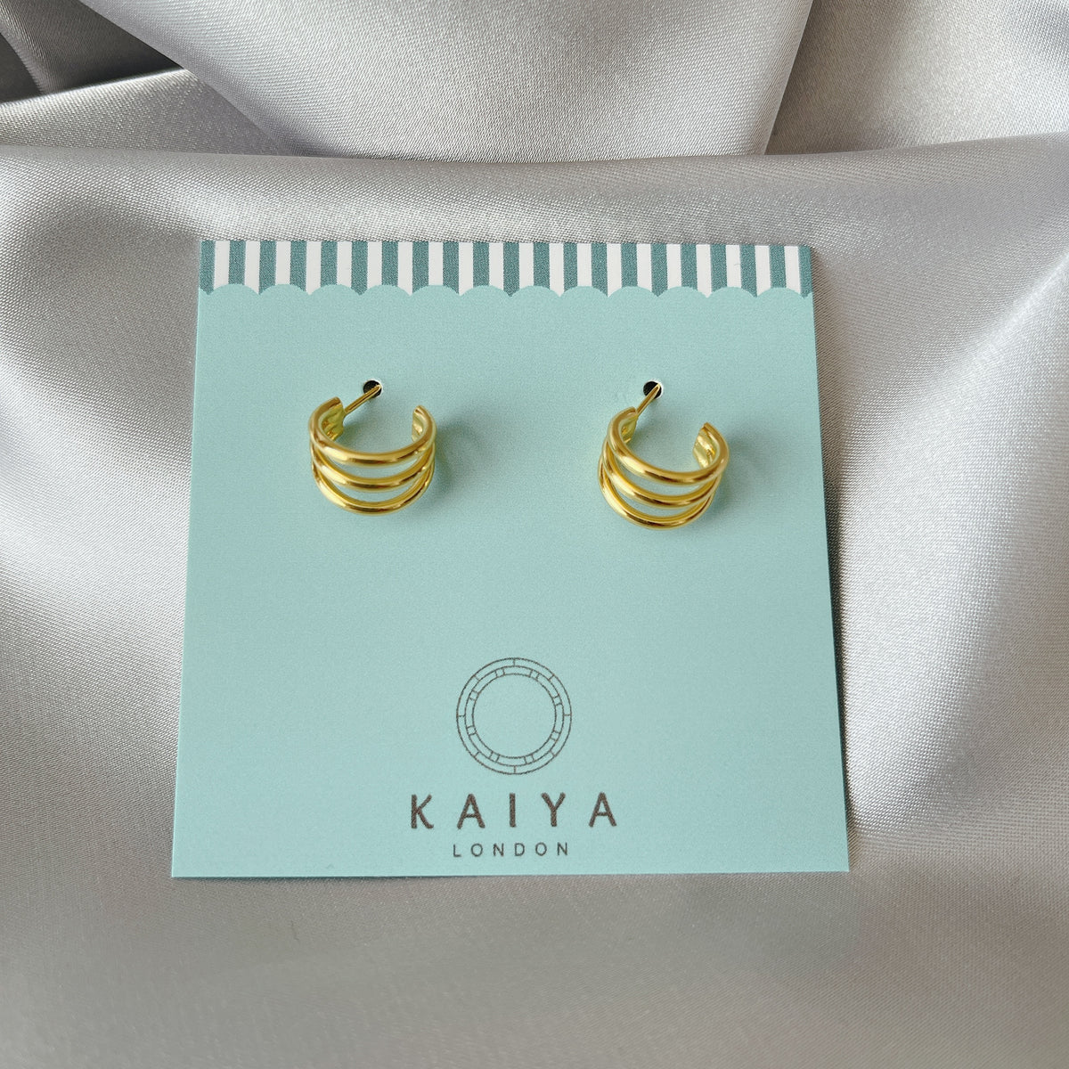 triple dot climber earrings close up three gold dots