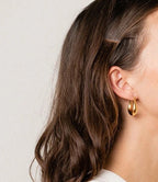 open oval gold hoop earrings close up minimalist design