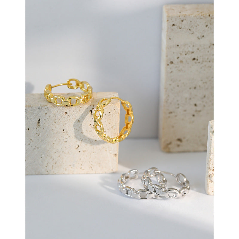 gold chain link drop earrings worn on model ear