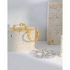 gold chain link drop earrings worn on model ear