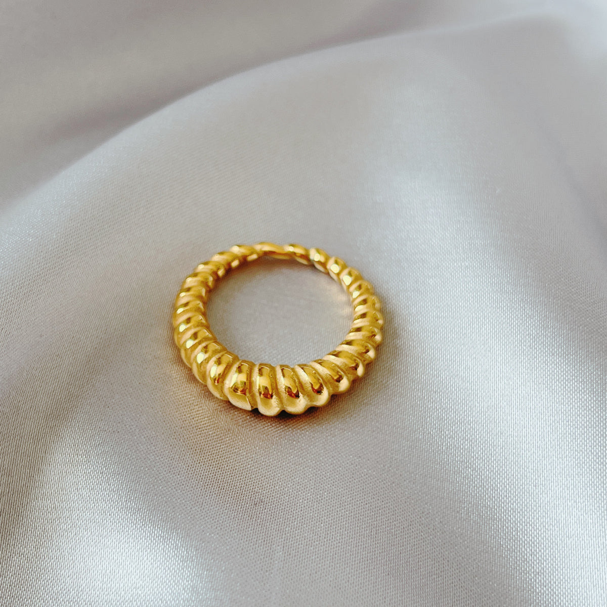 gold sculptural band ring worn on model hand