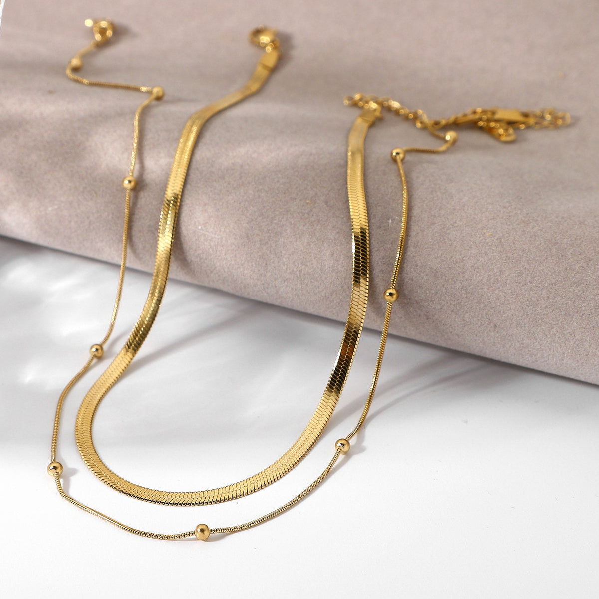 gold herringbone choker necklace close up texture detail
