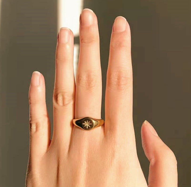 gold flat signet ring close up polished surface