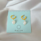 gold pearl huggie hoop earrings close up pearl detail