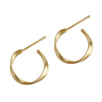 gold organic shape stud earrings worn on model ear
