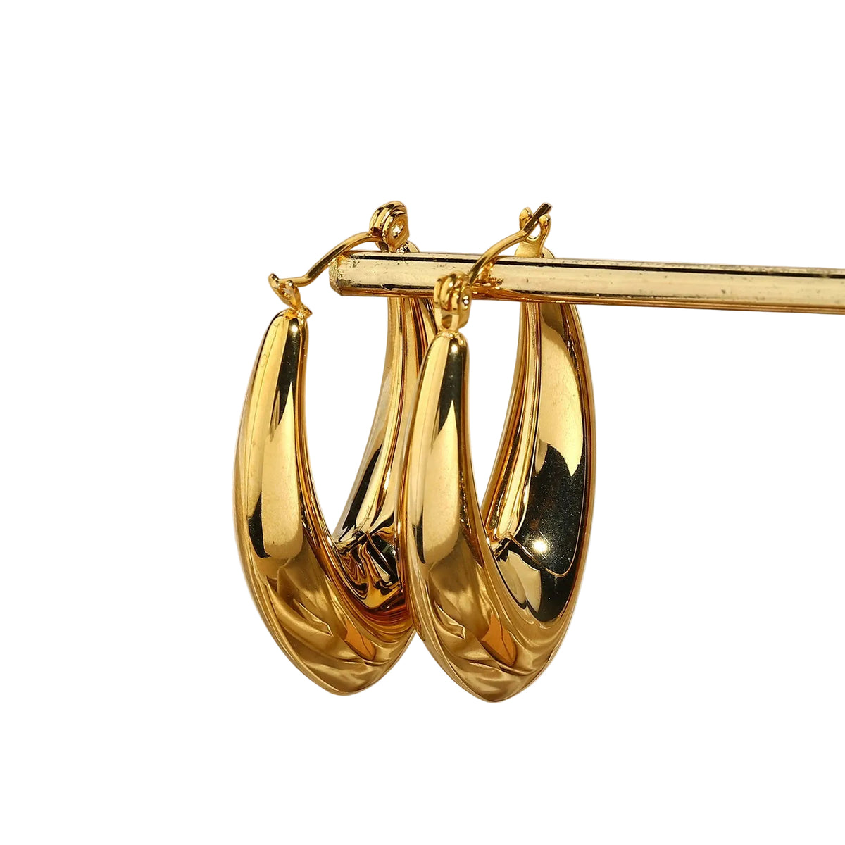 sculptural gold oval hoops styling shot PVD coated