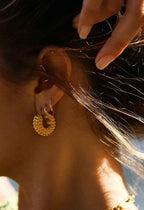 large textured gold hoop earrings close up edge detail