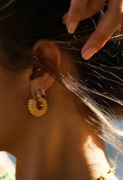 large textured gold hoop earrings close up edge detail