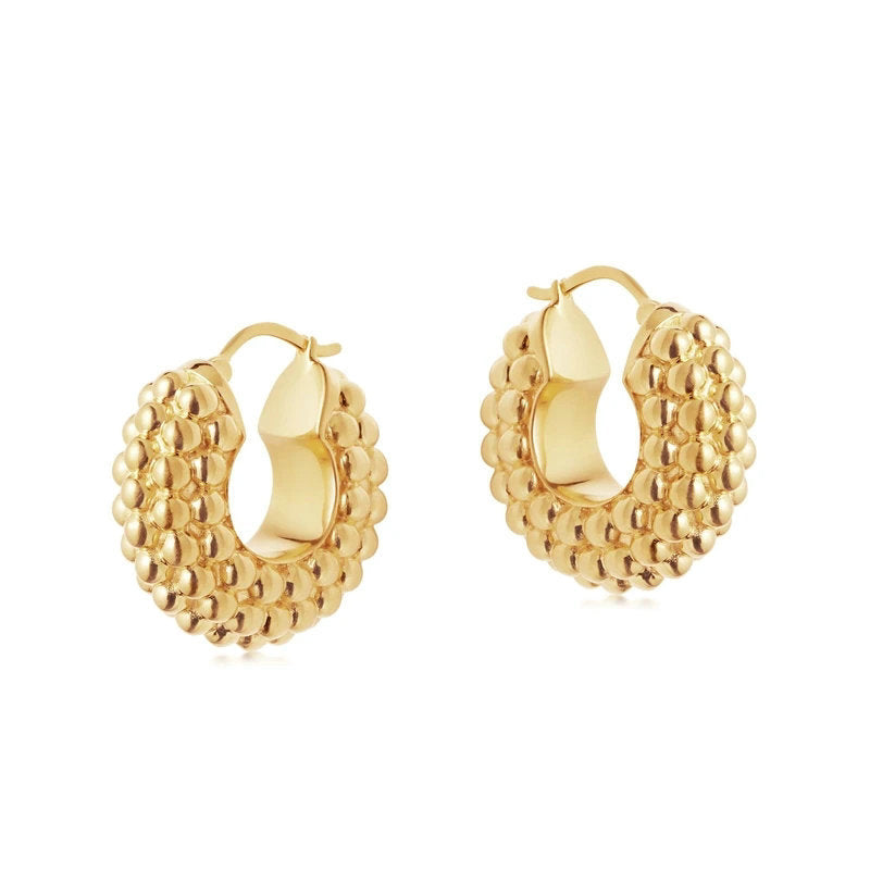 large gold textured hoop earrings on model
