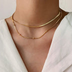 gold herringbone choker and beaded chain necklace set worn on model