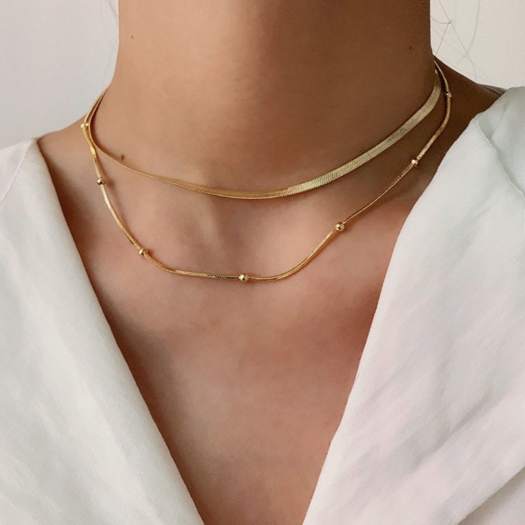 gold herringbone choker and beaded chain necklace set worn on model