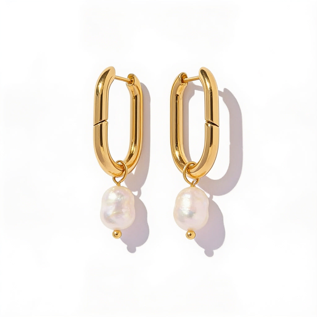 oval gold pearl hoop earrings side view on model