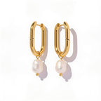 oval gold pearl hoop earrings side view on model