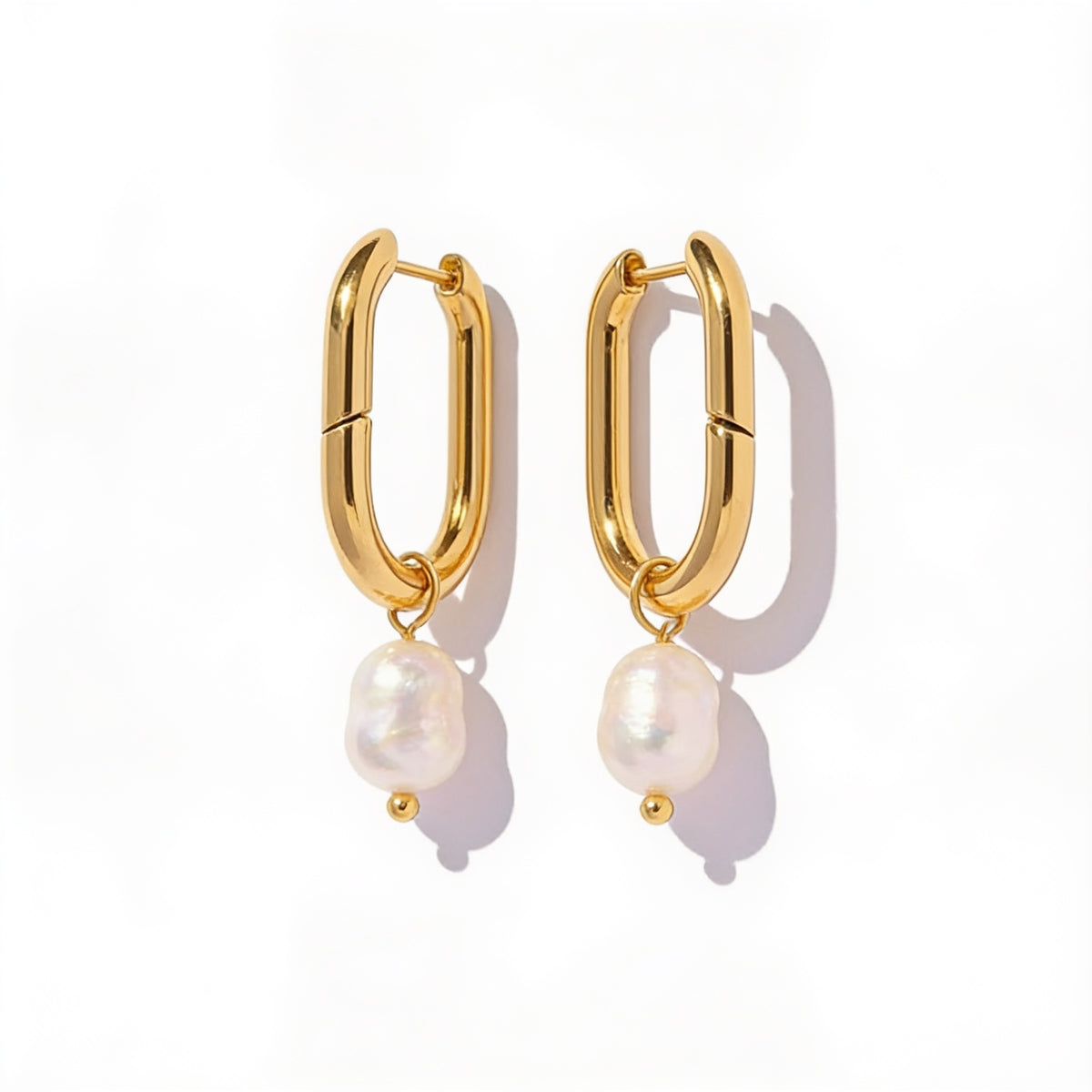 oval gold pearl hoop earrings side view on model